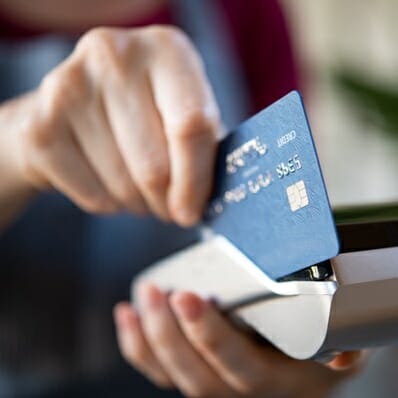 Hand holding credit card potentially vulnerable to cybersecurity or phishing attacks